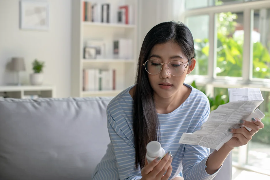 a woman checks the instructions when taking oral semaglutide and levothyroxine