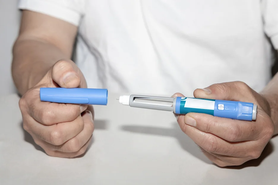 a man is holding a semaglutide pen